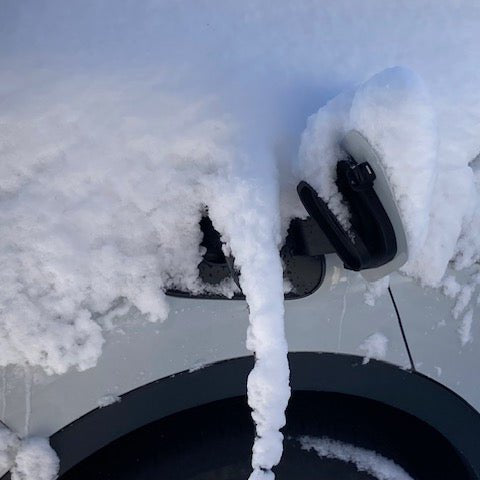 VW ID.4 charging outdoors with charging port snow cover installed
