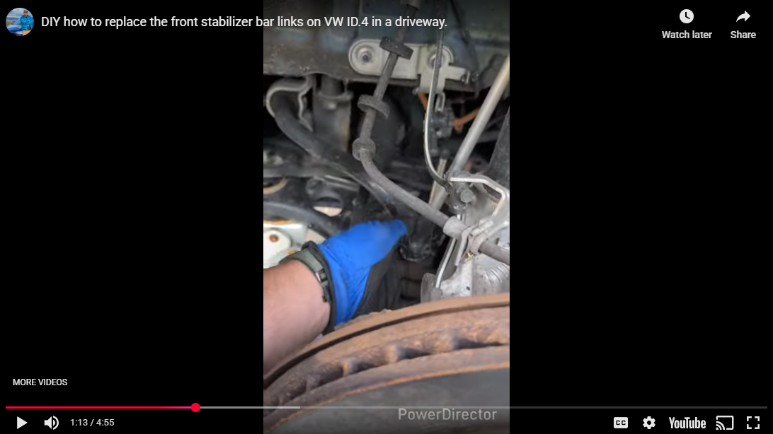 Load video: Video: A person replaces the front stabilizer bar links on a Volkswagen ID.4 in a driveway. The camera pans across the tool-table, lifts the front axle, removes the worn links, installs new ones, and tests the suspension movement. DIY home repair style, clear step-by-step actions.