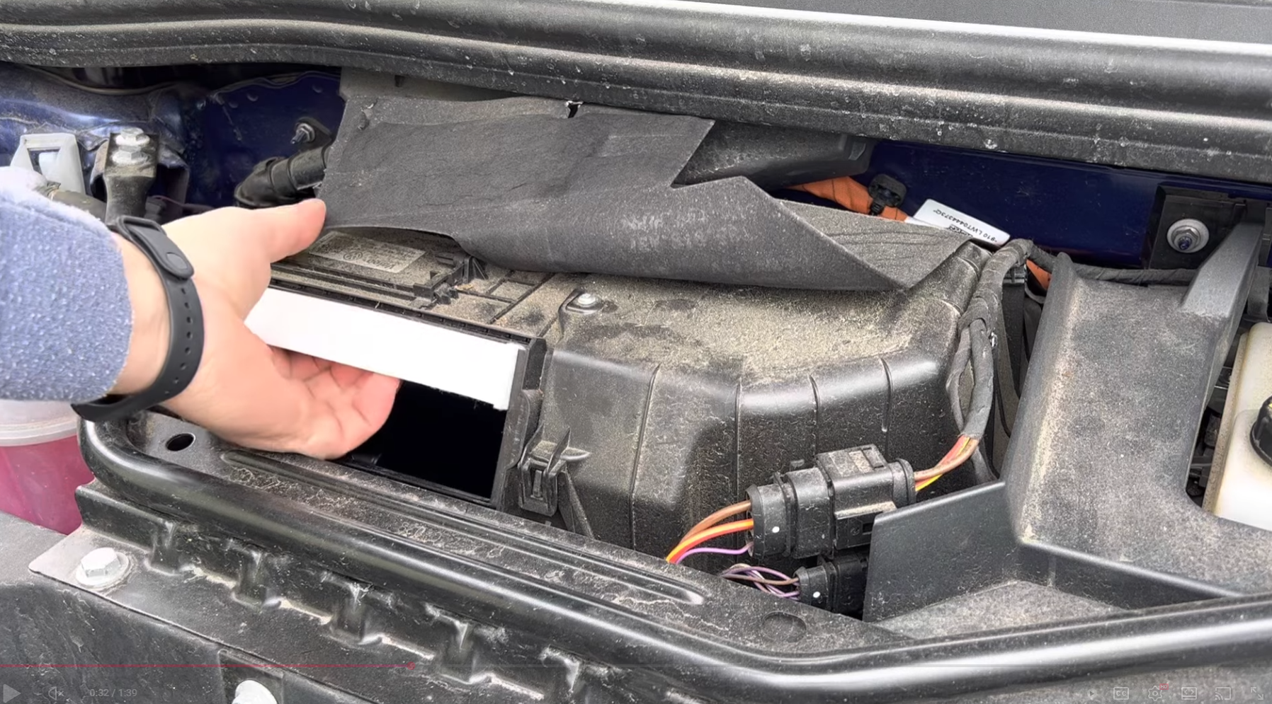 Load video: Video: Step-by-step DIY tutorial on changing the cabin air filter in a Volkswagen ID.4. The presenter shows which panels to open, how to remove the old filter from the HVAC housing, insert the new filter in the correct orientation, and reassemble everything, with close-up shots of the parts and tools used.