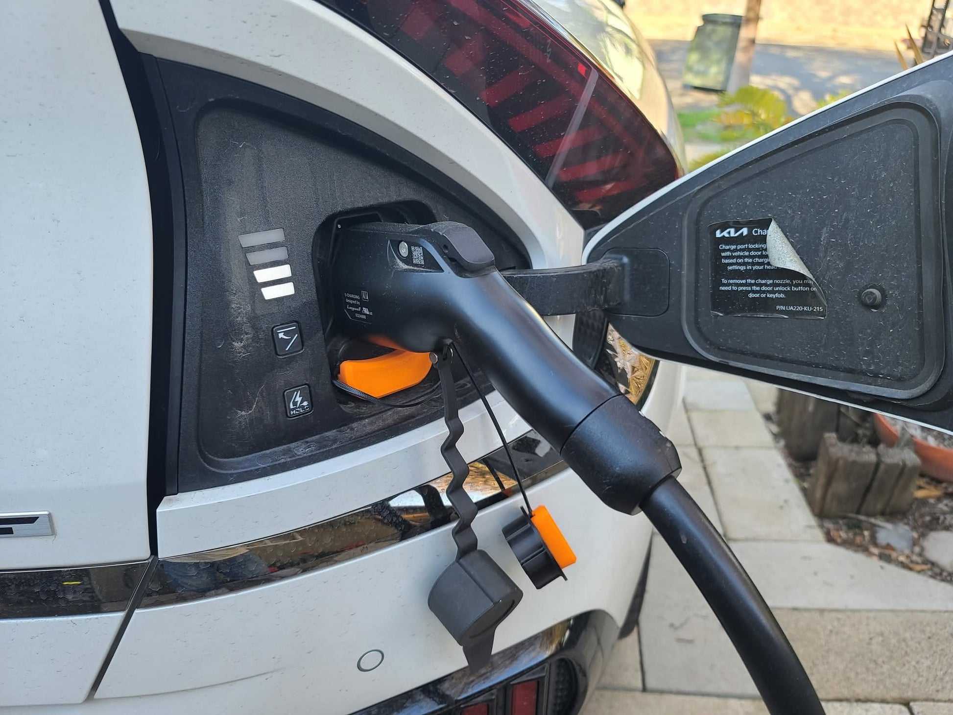 AC and DC port covers from YURIK Accessories installed on KIA EV6